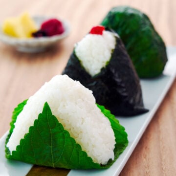 The ultimate guide to making Japanese Rice Balls, or onigiri, and shaping them into perfect triangles without a mold.