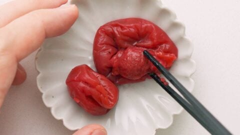 Removing pits from Umeboshi with chopsticks.