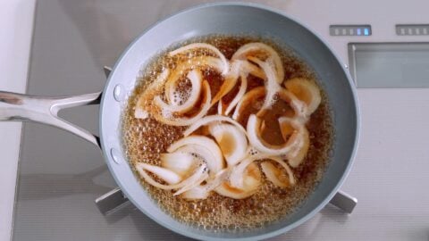 Onions simmering in dashi with soy sauce, sake and sugar.