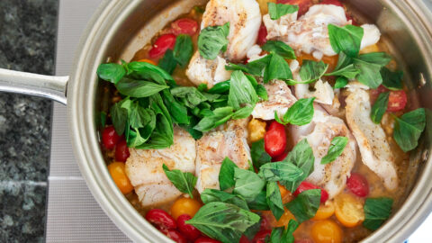 Add the pan-roasted cod back into the pan along with the basil.