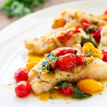 Simple and flavorful this pan-roasted cod is served with an easy pan-sauce made from white wine, tomatoes and basil.