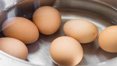 Brown eggs in a pot large large enough to hold double the amount of eggs, covered with an inch of water.