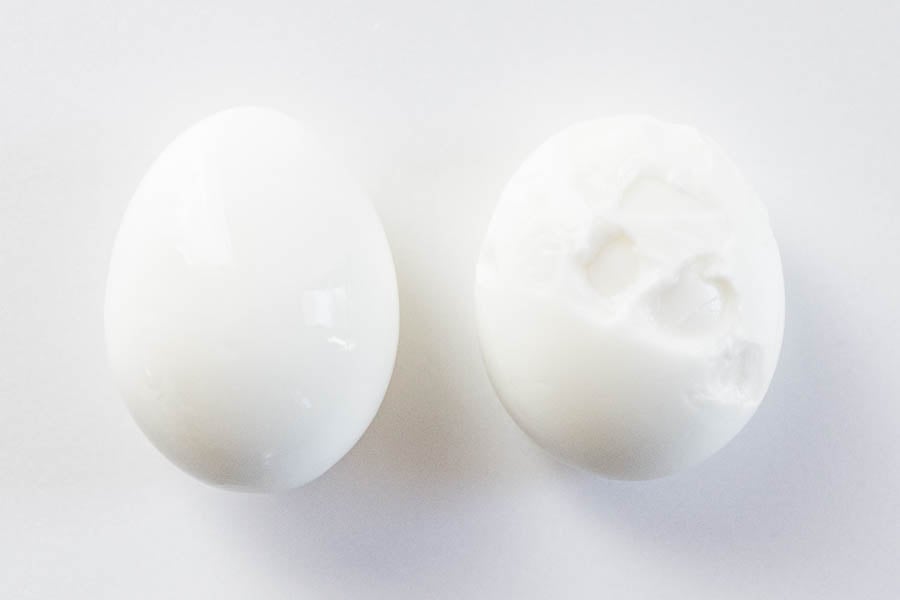 Perfectly peeled boiled egg on the left using my trick, damaged boiled egg on the right.