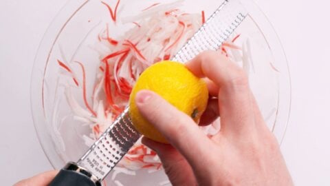 Grating yuzu zest onto Kohaku Namasu.