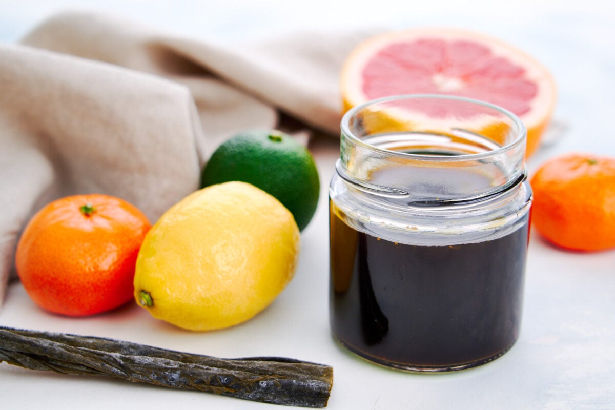 Bottle of homemade ponzu sauce with konbu and citrus fruits.