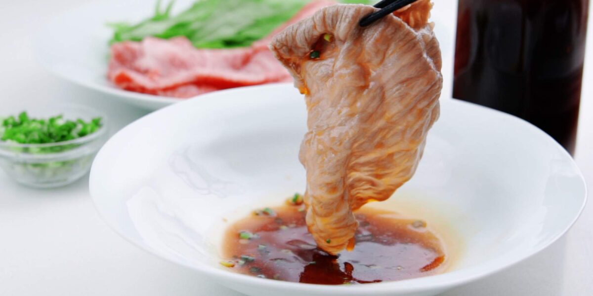 Dipping beef shabu shabu in ponzu sauce.