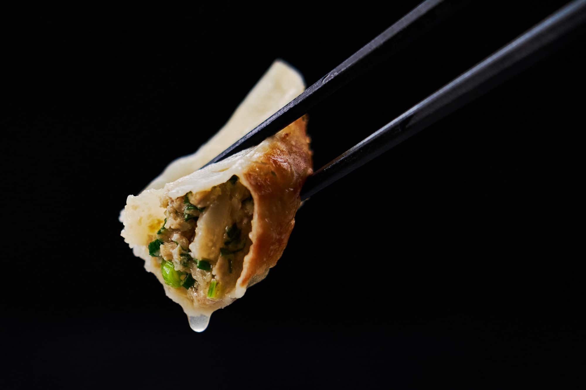 Crispy Japanese gyoza dripping with juices.