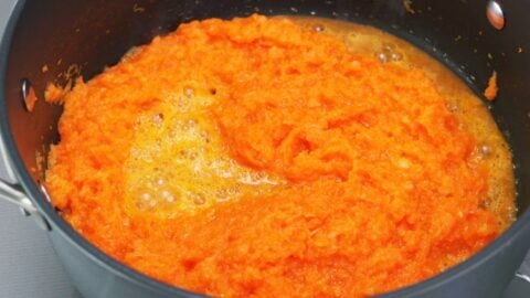 Boiling the liquid off of the grated vegetables.