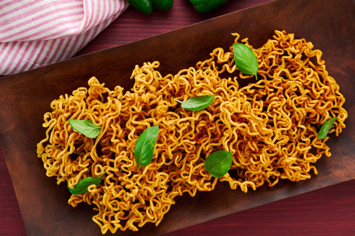 Wooden platter of crispy fried ramen chips.