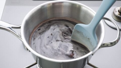 Stirring red bean soup with a spatula.