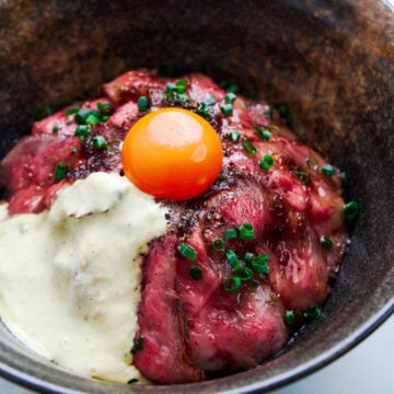 Easy stove top Japanese roast beef rice bowl with pan roasted A5 grade wagyu, an onion glaze, and tangy wasabi cream.