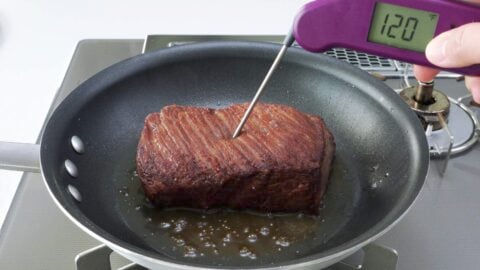 Checking roast beef with an instant read thermometer.