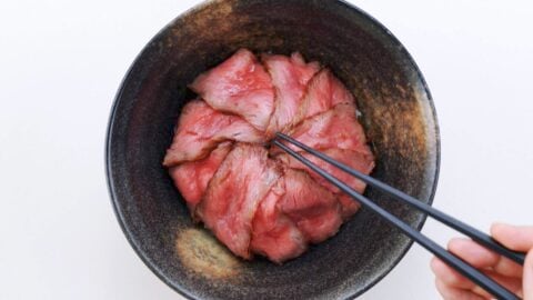 Thin slices of roast beef in a bowl.