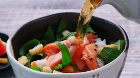 Pouring tea over salmon and and rice to make ochazuke.