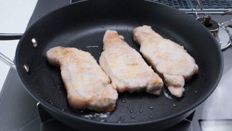 Ginger pork chops in a frying pan.