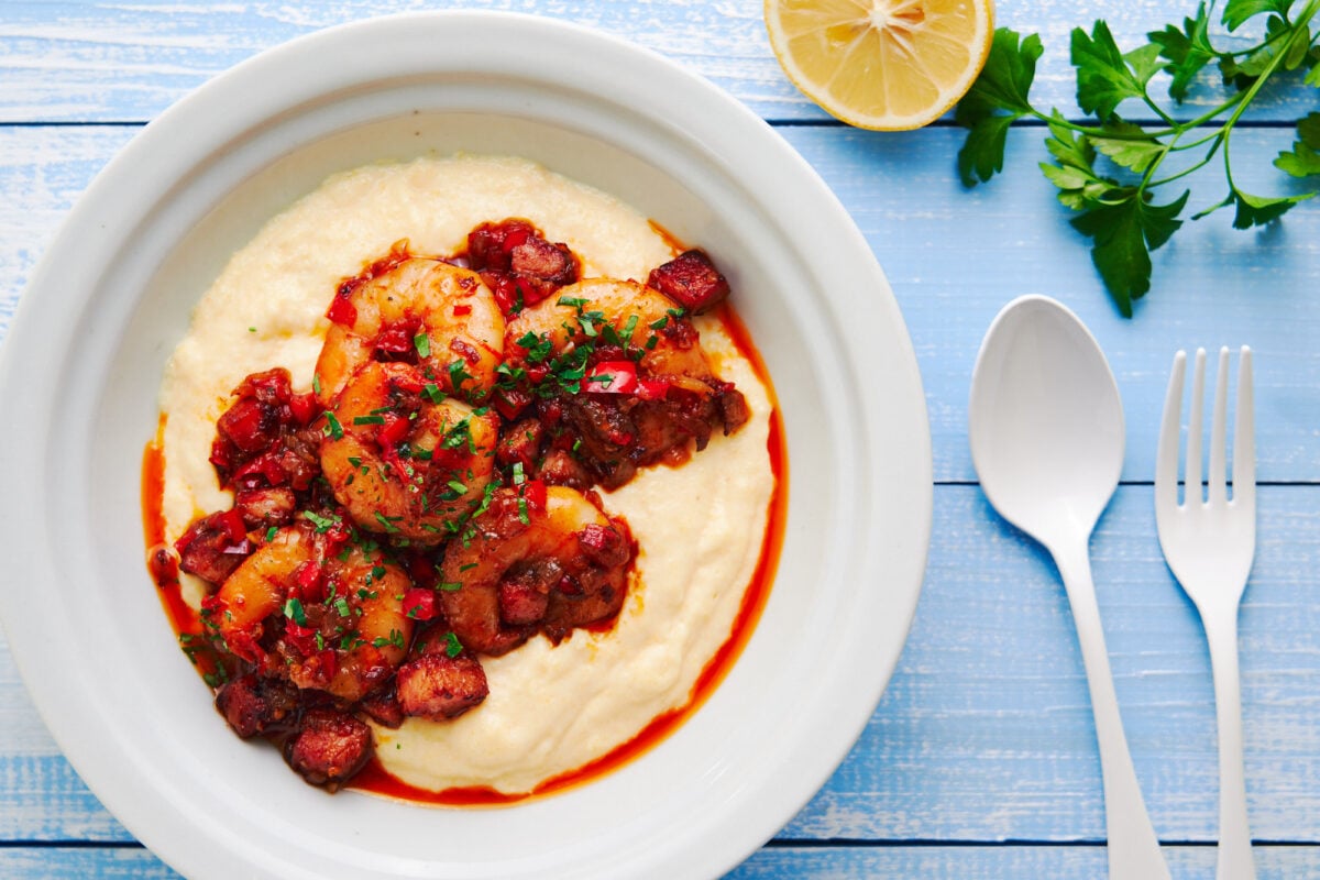 The best shrimp and grits recipe, made with smoky cajun shrimp, served on a bowl of cheddar cheese grits.