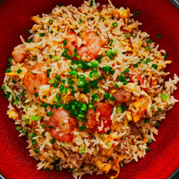 The best shrimp and egg fried rice in a red ceramic bowl.