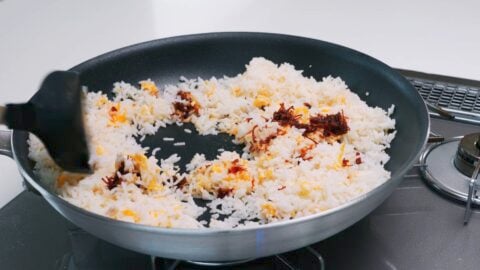 Egg fried rice in a frying pan.