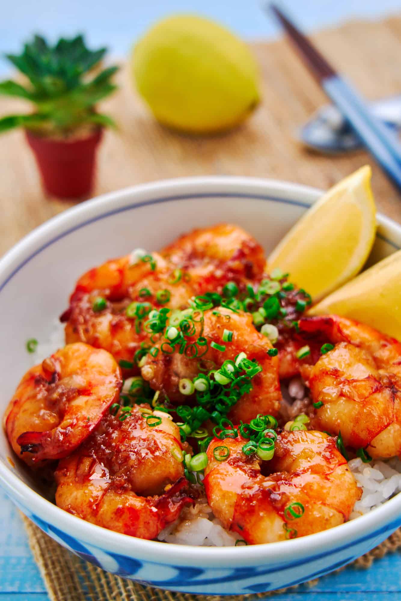 Easy shrimp rice bowl with plump juicy shrimp glazed with a decadent garlic butter-soy sauce on a bed of rice.