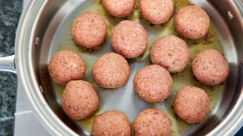 The best meat balls are pan fried, this forms a brown crust around the meatball that adds flavor to the marinara sauce.