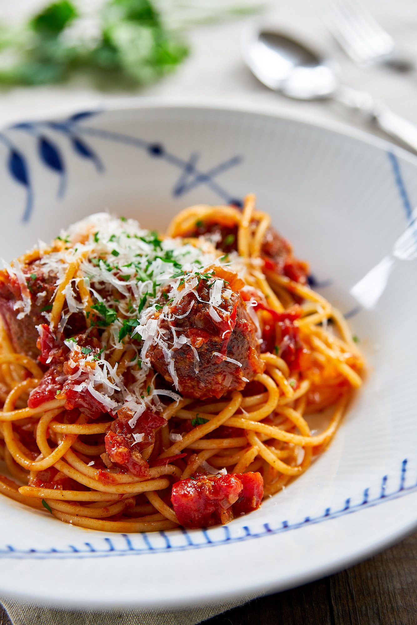 The ultimate guide to making the best Spaghetti and Meatballs, includes tips on the meat, aromatics, seasonings, fillers, and cooking techniqes to make the juciest, most tender, and flavorful meatballs.