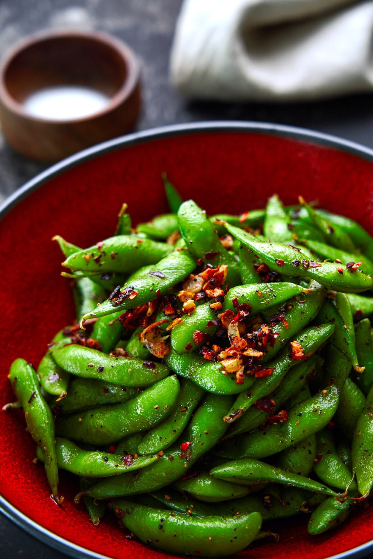 Up your snack game with this Spicy Edamame recipe that's loaded crispy garlic and a double hit of black pepper and chili peppers.