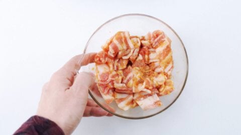 Marinating pork belly with garlic, ginger, and soy sauce.