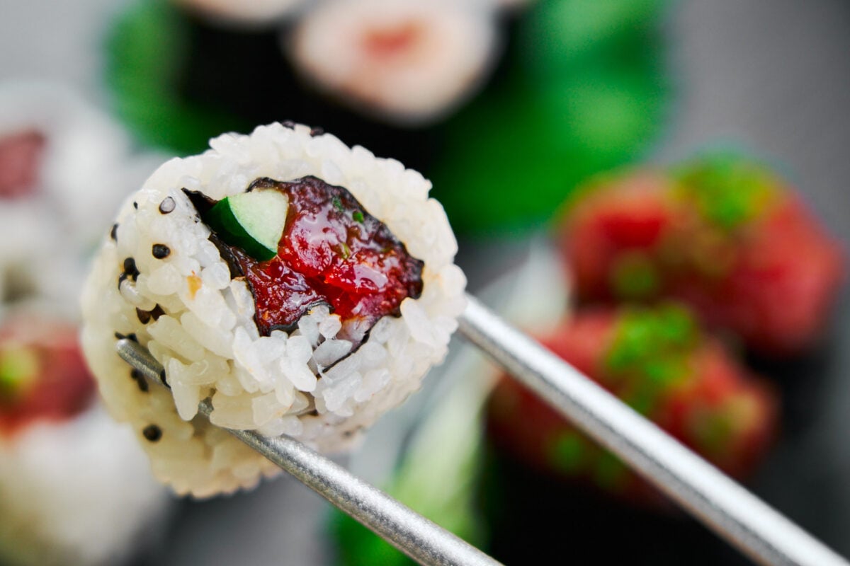 Easy spicy tuna roll recipe with cucumber and black sesame seeds.