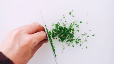 Chopping scallion greens.