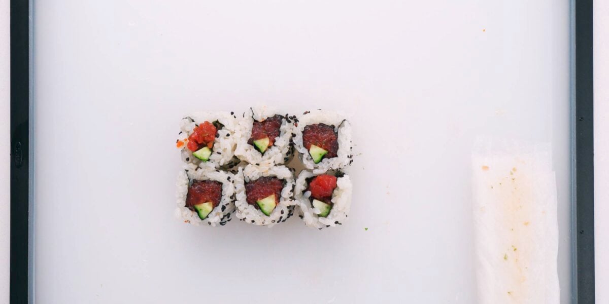 Flip the spicy tuna roll so the cut ends are facing up.