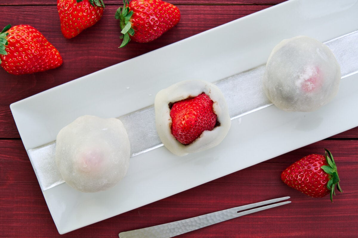 Strawberry mochi, a type of Japanese dessert is stuffed with a whole fresh strawberry.