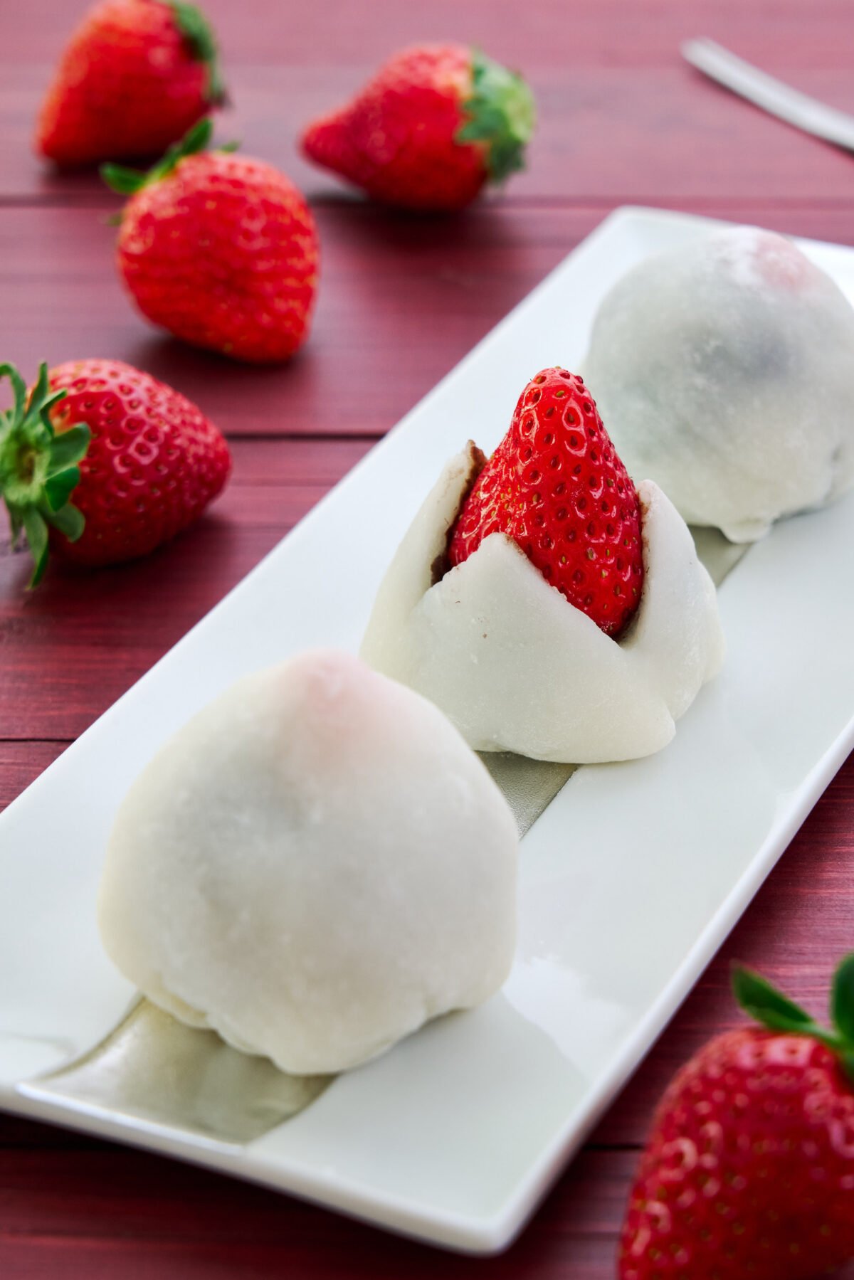 Strawberry Mochi, or Ichigo Daifuku is a Japanese dessert made with a fresh strawberry wrapped in soft, sticky mochi and sweet anko.