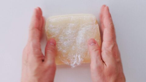 Shape the mochi into a square using plastic wrap to keep it from sticking.