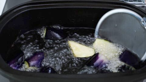 Deep frying eggplant.