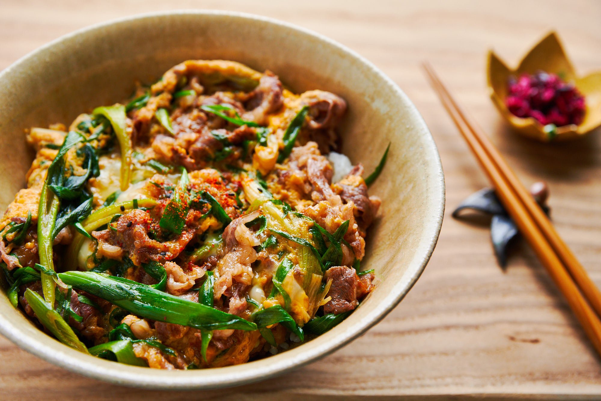 With thinly sliced beef and scallions cooked in a savory sweet sauce with egg, this easy Japanese rice bowl is quick and delicious.