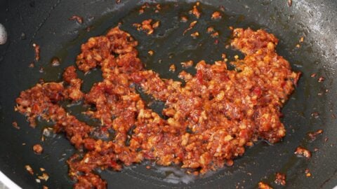 Caramelized aromatics and pork for making tantanmen broth.