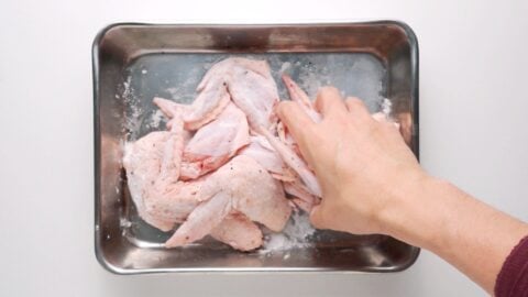 Coating chicken wings with potato starch allows the sauce to adhere to them.