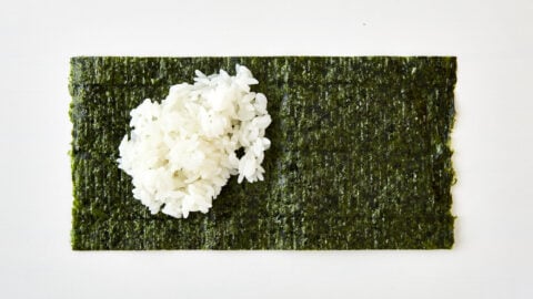 Add some rice to the rough side of the nori for Temaki Sushi.