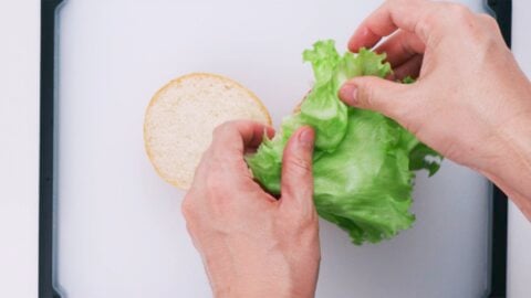 Add the lettuce to the sandwich.