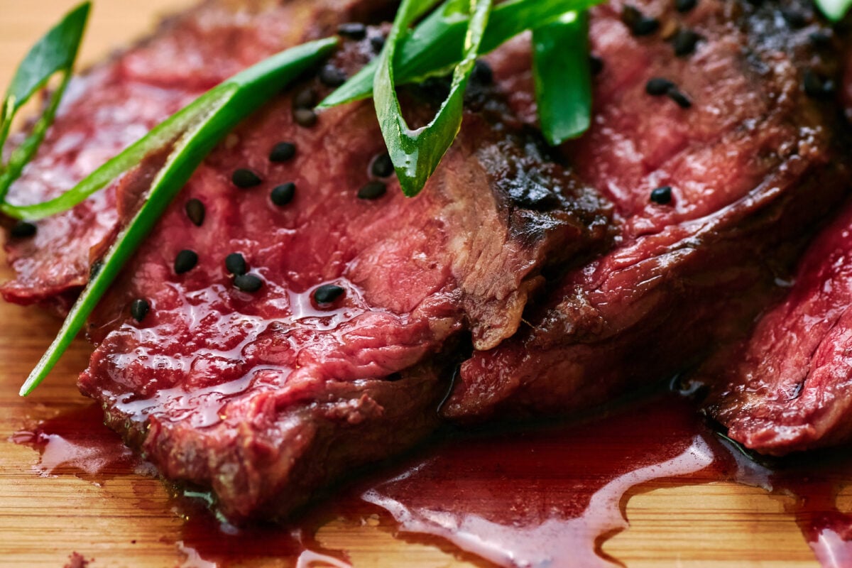 Slices of rare hanger steak glazed with Japanese teriyaki sauce.