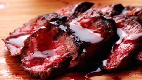 Closeup of grilled hanger steaks with shiny teriyaki sauce.