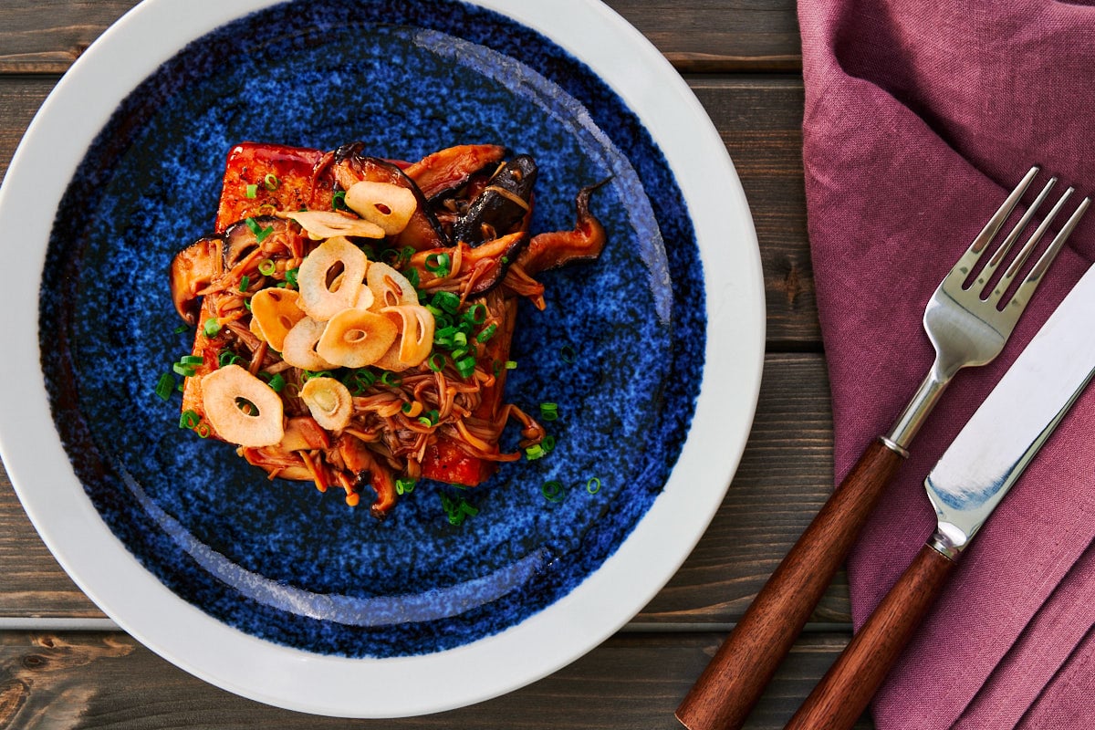 This tofu steak topped with mushrooms and crispy garlic chips is an easy protein-packed meal that's brimming with flavor.