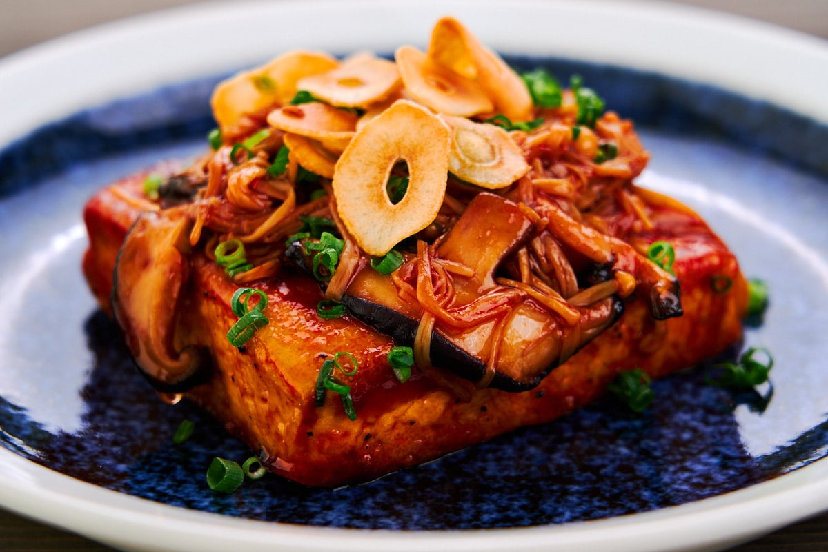 Japanese tofu steak topped with sauteed mushrooms and crispy garlic chips.