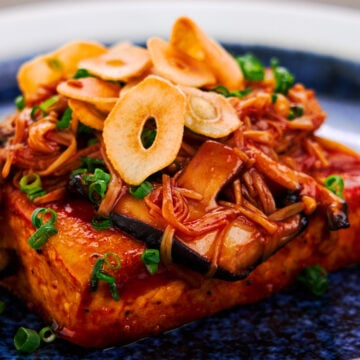 Japanese tofu steak topped with sauteed mushrooms and crispy garlic chips.