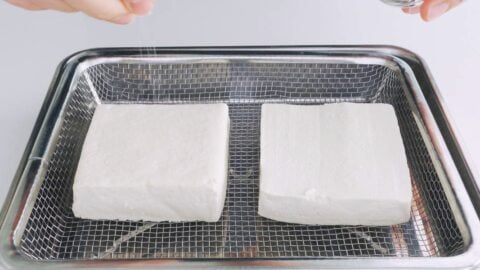 Tofu steaks being salted and drained.