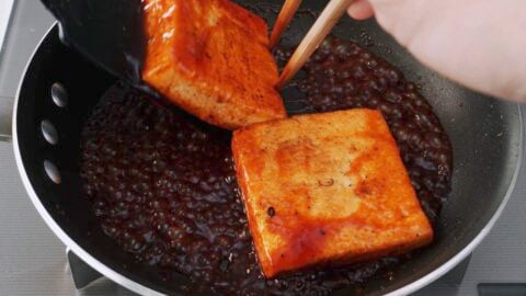 Glazing tofu steaks with Japanese steak sauce.