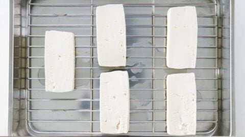 Draining tofu on a wire rack.