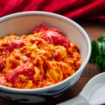 Juicy sweet tomatoes stir-fried with creamy scrambled eggs over a bowl of rice.