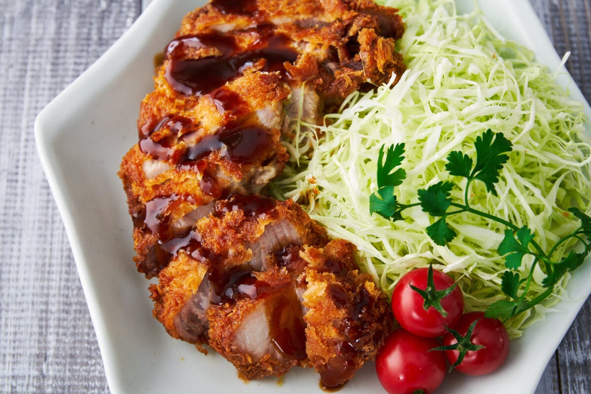 Crisp, juicy Tonkatsu (Japanese pork cutlet) drizzled in a sweet and savory spiced fruit sauce.