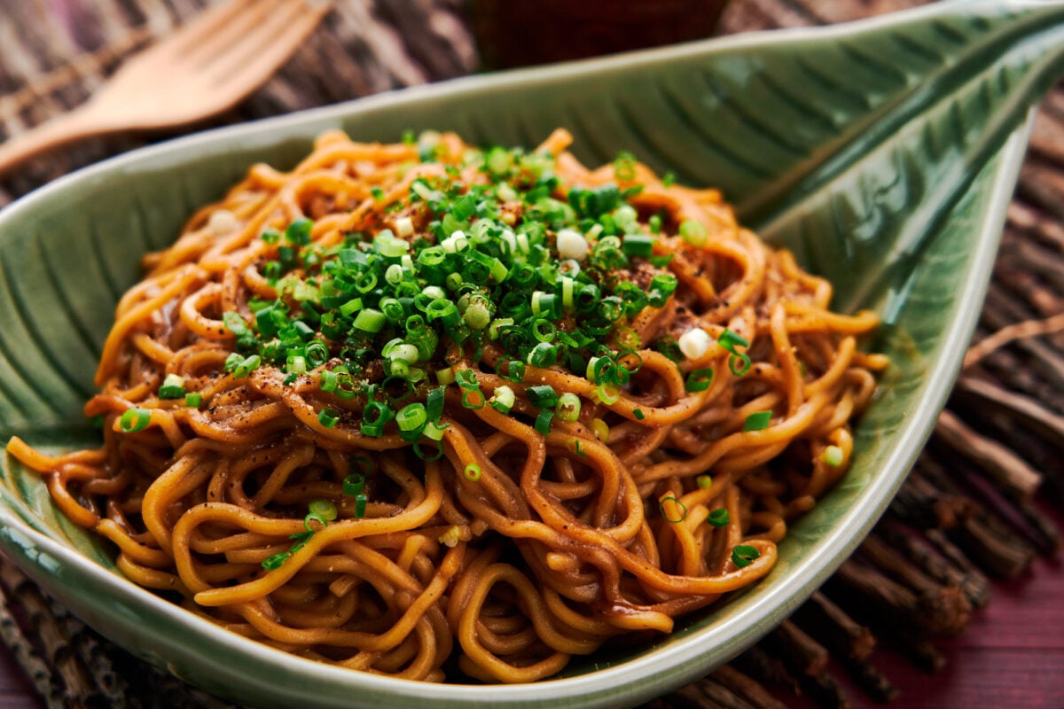 The best Asian-style garlic noodles topped with black pepper and scallions.